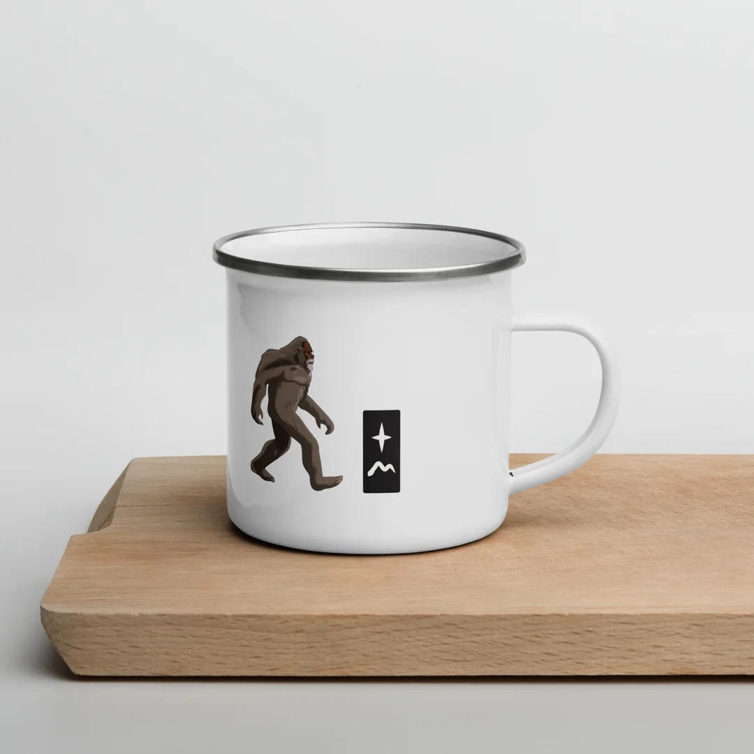 The Lift Your Eyes camp mug on a wooden board.