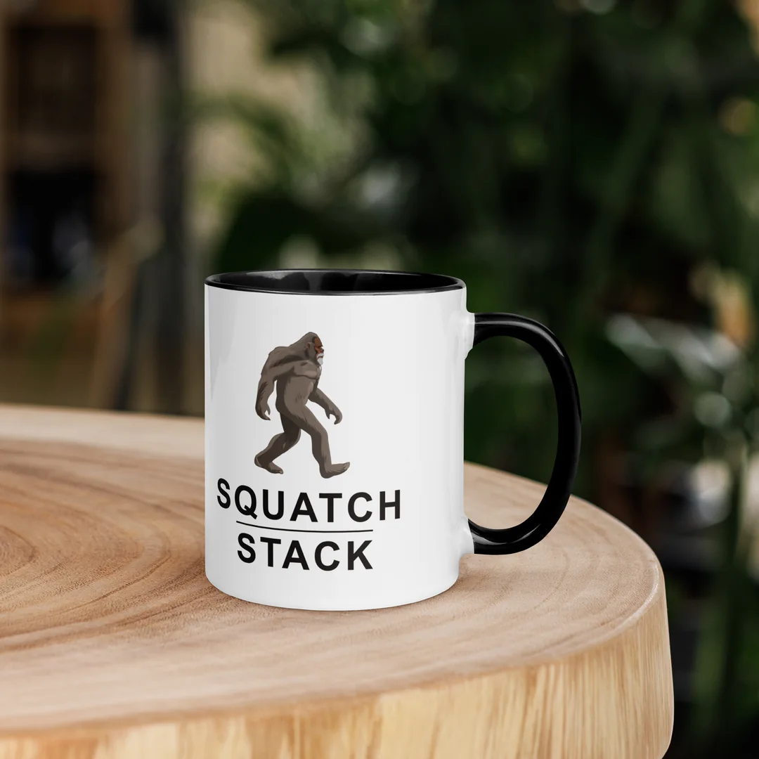 The Founder mug on a wooden stump.