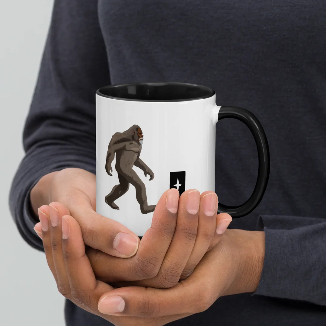 The Grace and Grit mug, held in two hands.