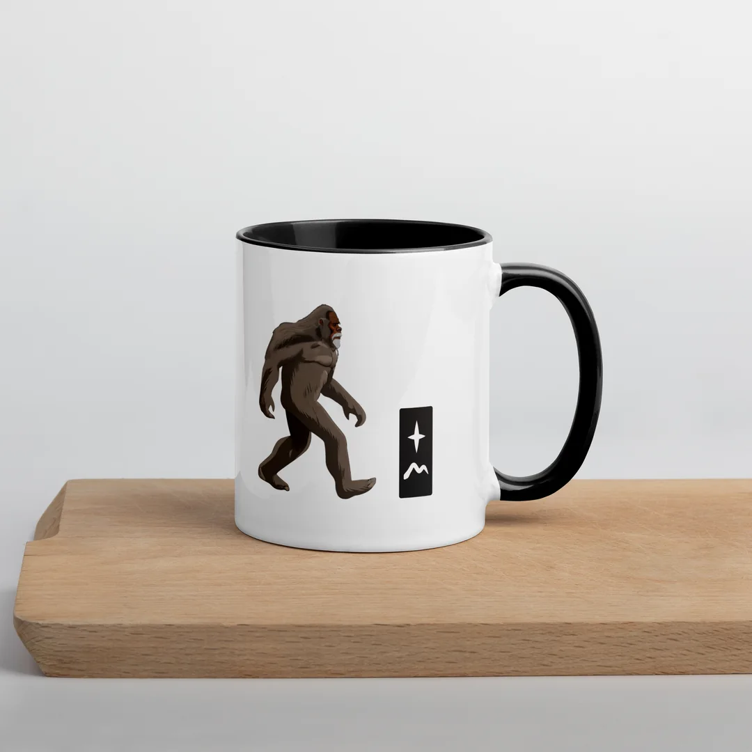 The Gone Walking mug on a wooden board.