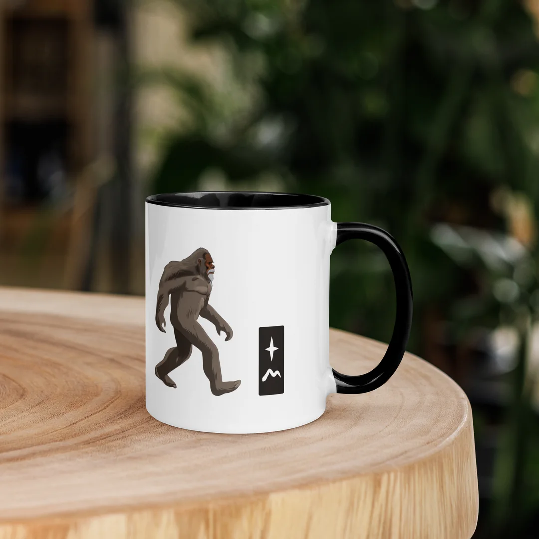 The Gone Walking mug on a wooden stump.